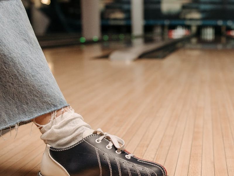 Close-up of sports equipment on a dark wooden floor.